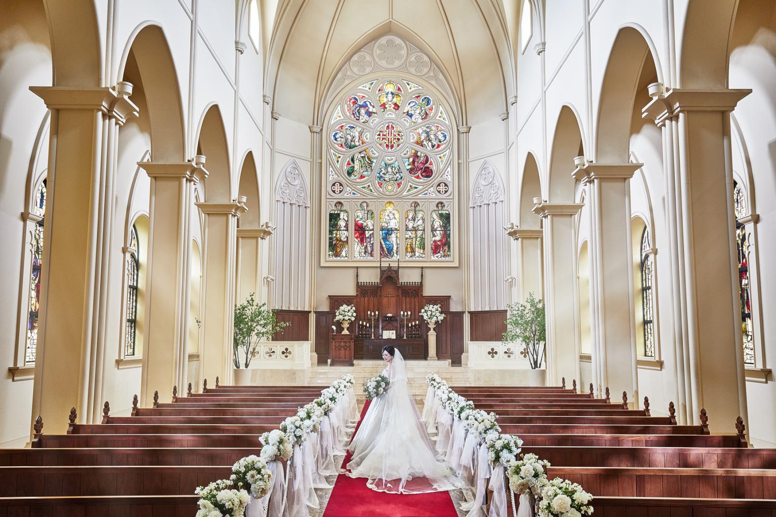 100年以上もの歴史を受け継ぐバラ窓のステンドグラスと、全長23mのバージンロードが魅力の大聖